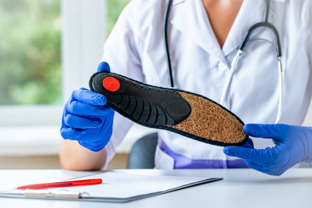 Doctor holds orthopedic insoles for flat feet treatment and prevention of flat feet. Foot care
